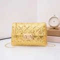 Detail of gold sequin crossbody bag featuring quilted diamond pattern and chain strap - Yellow