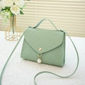 Light green textured crossbody bag with elegant pearl pendant and envelope flap closure - Green