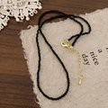 Detail of black faceted bead necklace with gold lobster clasp and adjustable extension chain - Black