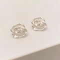 Detail shot of silver camellia stud earrings showing layered 3D floral petals and matte finish - Silver
