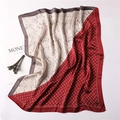 Detail of silk-feel scarf with paisley patterns, bicolored red and ivory with Monet art prop - Red and Beige Paisley