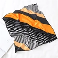 Detail of silk-like orange and black polka dot scarf folded on a white book - Orange Black White Stripe Polka Dot Style (FX-141)