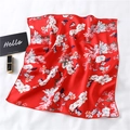 Detail of red silk scarf with floral and butterfly prints laid on a white fabric - Bright Red Butterfly Print Style (FX-129)