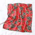 Detail showing red silk scarf with leopard hearts and gold chain print on bed - Red Black Leopard Heart Chain Style (FX-103)