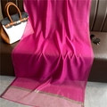 Detail of fuchsia silk blend scarf with elegant gold metallic stitched edges on leather - Rose Red