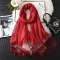 Detail of red silk scarf with silver edge stitching and sparkling bead embellishments - Red