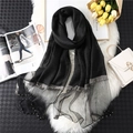 Close-up of black scarf featuring sheer mesh splicing with pearls and silver woven trim - Black