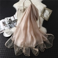 Elegant champagne silk scarf with beaded wavy edges displayed with stylish lifestyle props - Apricot