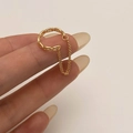 Detail of gold chain link ring with a minimalist open design and dangling metal fringes - Gold Chain Ear Cuff