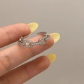 Detailed macro view of silver adjustable chain ring with shimmering pave-set cubic zirconia - Silver