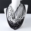 Elegant black and white polka dot silk scarf with stripes on a white mannequin - Black & White