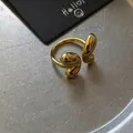 Macro shot of gold-plated open ring with sleek fluid design and polished bean detail - Gold Adjustable Ring / Gold