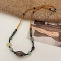 Handmade necklace with amber beads, green natural stones, and brown patterned pendant - Amber Rice Bead Imitation Dzi Style (B-426)