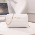 White quilted crossbody bag with gold chain strap and brand logo on marble table - Quilted Diamond Style / White