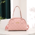 Pink quilted shell-shaped handbag with adjustable strap on a marble surface - Pink
