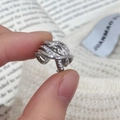 Detailed view of silver layered cross rings with micro-set zircon on fluid metal bands - Silver