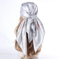 Silver satin scarf with floral prints and silk texture shown on a white background - Light Gray