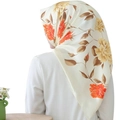Elegant ivory satin hijab with orange floral prints showing smooth drape on model - 90x90cm / Orange