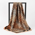 Satin leopard print silk square scarf hanging on a black metal display frame - BX183 Khaki Leopard