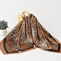 Elegant leopard print 90cm square silk scarf in earth tones on a woven straw bag - Standard Spec / Dark Color
