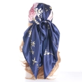 Navy blue satin headscarf with pink floral and gold leaf prints shown on a model - Navy Blue