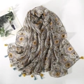 Detail of paisley print scarf in beige with colorful floral patterns and tassels - Brown