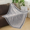 Detail of floral pattern on breathable voile square scarf displayed on a sofa - Vintage Cream Blue Pink Ditsy Floral Style (Style 7)