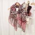 Detail of pink leopard print scarf displayed on a wooden hanger with fashion accessories - Spliced Leopard-Pink