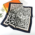 Detail of silk-like leopard print scarf featuring navy blue borders and satin finish - Leopard Style 16