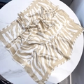 Detail of elegant leopard print silk scarf showing texture and hem on marble background - Leopard Style 5