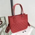 Red quilted leather tote bag with dual handles and wide fabric shoulder strap - Red
