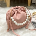 Pink drawstring bucket bag in lychee pattern leather with elegant pearl handle strap - Pink