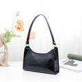 Glossy black crocodile pattern shoulder bag with golden hardware and chic baguette style - Black