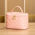 Pink quilted square makeup bag with top handle and gold zipper on a wooden surface - Large / Pink