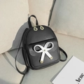 Mini black synthetic leather backpack featuring white bow and golden leaf charms - Black