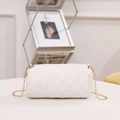 White quilted barrel crossbody bag with gold chain strap and elegant rhombic pattern - White