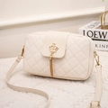 Elegant cream white quilted crossbody bag with golden crown buckle and tassel charm - White
