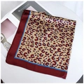 Detail of burgundy leopard print silk scarf flat lay on a table with a magazine - 70cmx70cm / Burgundy Border Cream Leopard (Style 7)