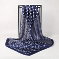 Navy blue silk scarf with white polka dots and paisley patterns on a black display stand - Navy Paisley Print