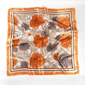 Detail view of the orange satin silk scarf featuring elegant large rose floral patterns - Orange