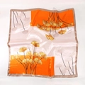 Detail of satin silk scarf featuring elegant lotus leaf patterns and smooth texture - Orange