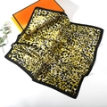 Macro detail of leopard print silk scarf texture and elegant satin glossy finish - Leopard Print