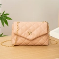 Elegant beige quilted crossbody bag with gold flower clasp and metallic chain strap - Pink