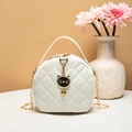 White quilted mini round bag featuring a cute black cat charm and elegant chain strap - White