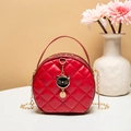 Red quilted round mini bag with chain strap and black cat charm on a stone table - Red