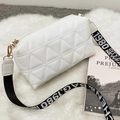 White quilted crossbody camera bag with wide striped strap on white faux fur background - White Geometric Style