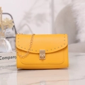 Modern bright yellow shoulder bag with gold rivets and elegant chain strap - Yellow