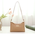 Close-up of beige shoulder bag featuring detailed diamond quilted embossed texture - Brown