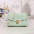 Chic mint green crossbody bag with gold chain strap and stud details on flap - Green