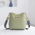 Light green crocodile pattern bucket bag with a wide black and white KUCHEN strap - Green